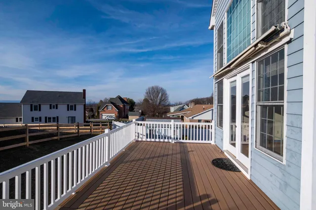 a bedroom with a large bed chandelier and a window
