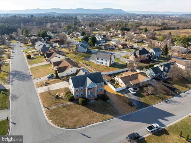 an aerial view of a house with yard swimming pool and mountain view