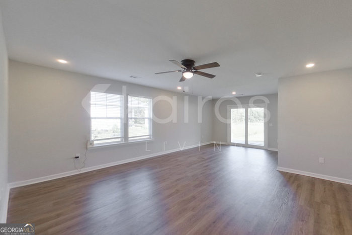 122 Cottage Grove Road Brunswick, GA 31525 - Photo 2 of 20 a view of an empty room with a window and wooden floor