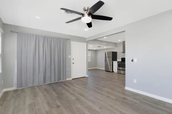 a view of empty room with wooden floor