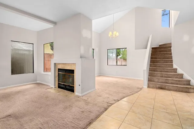 a view of an empty room with a fireplace and a window