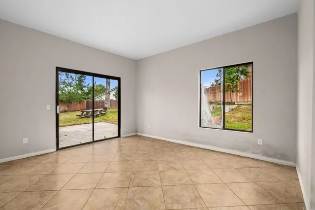 en empty room with sliding door and mountain view