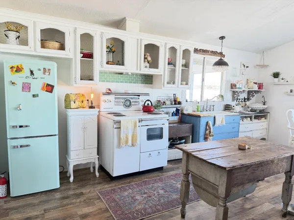 a kitchen that has a lot of counter space and wooden floor