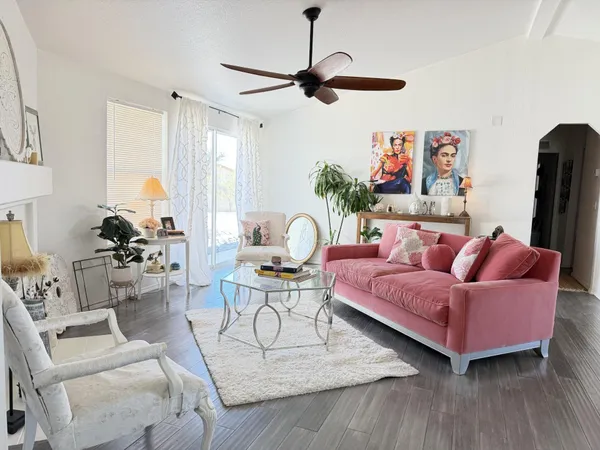 a living room with furniture and a chandelier