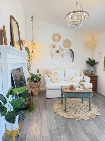 a living room with furniture and a potted plant