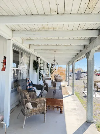 a view of a backyard with furniture and a fence
