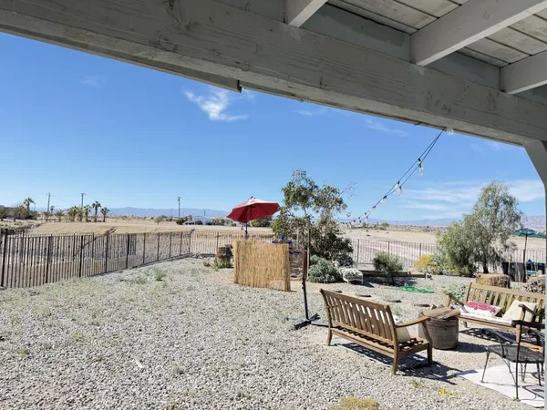 a roof deck with table and chairs potted plants