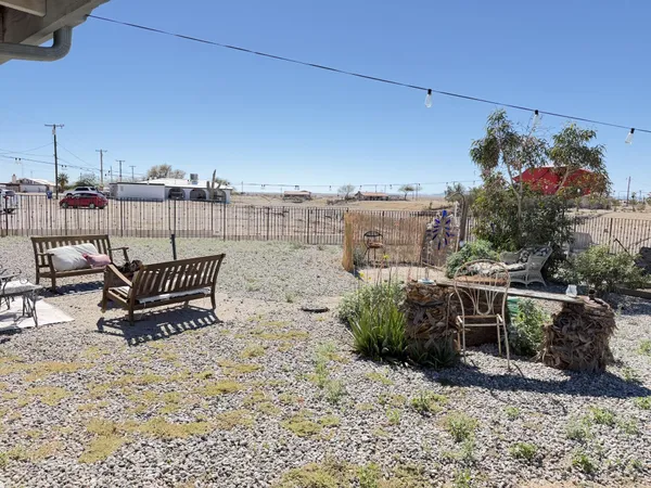 a backyard of a house with fire pit and outdoor seating