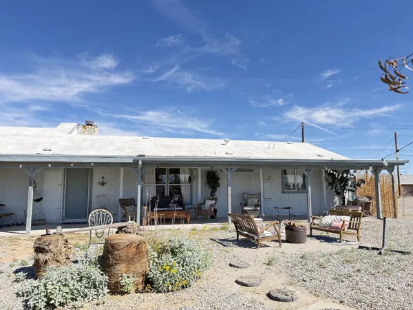 a view of a patio with a table and chairs under an umbrella