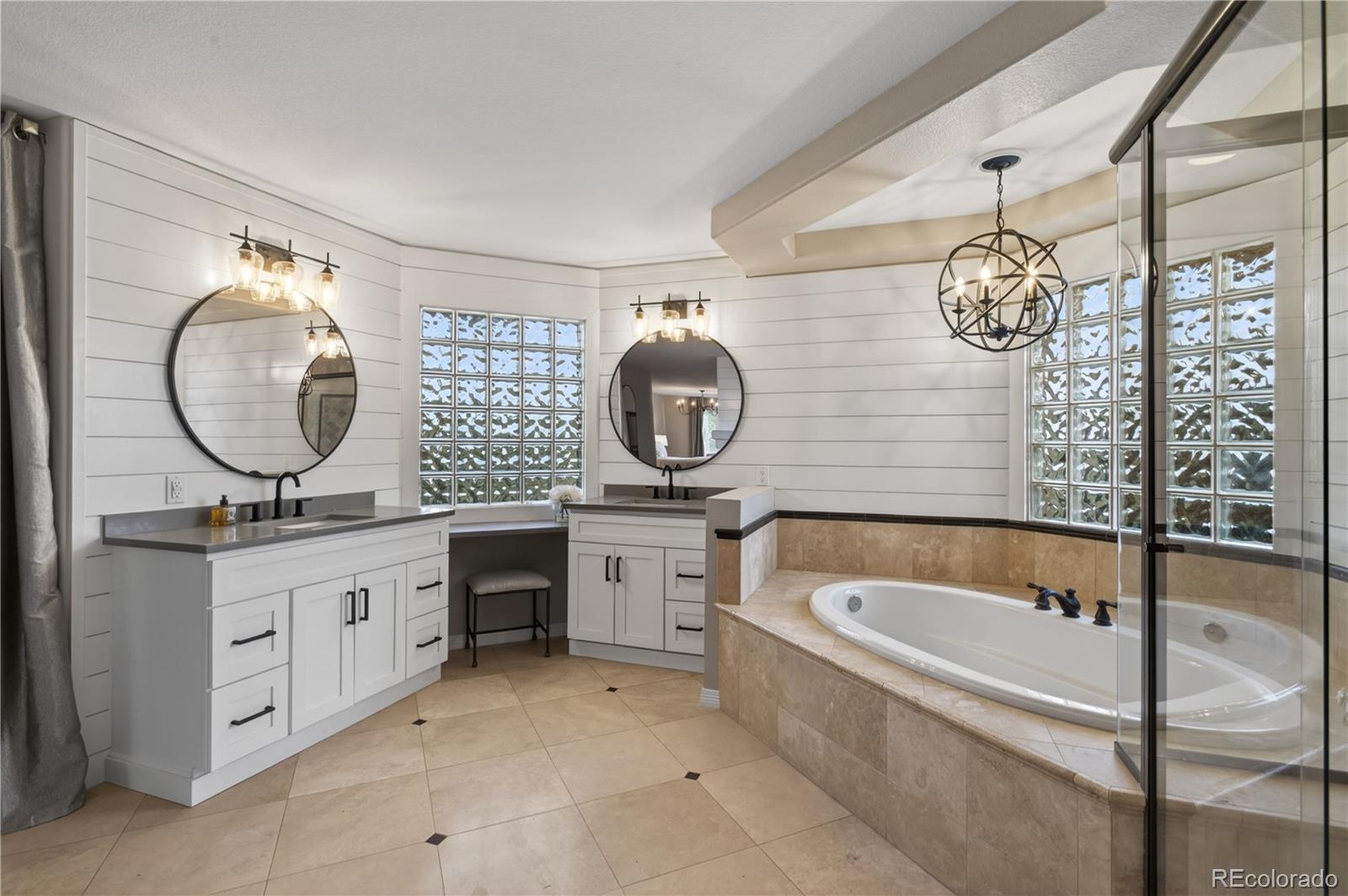 3041 Wyecliff Way Highlands Ranch, CO 80126 - Photo 29 of 50 a bathroom with a granite countertop sink a mirror and bathtub with shower