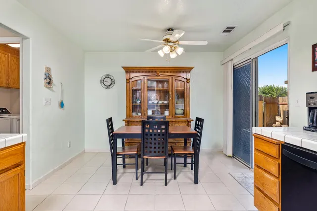 a view of a dining room with furniture and chandelier