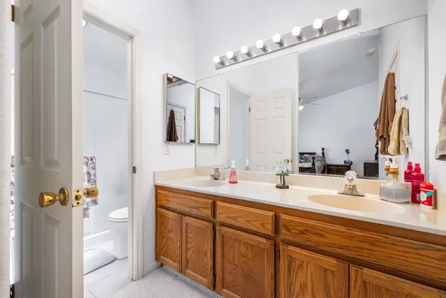 a bathroom with a double vanity sink mirror and double