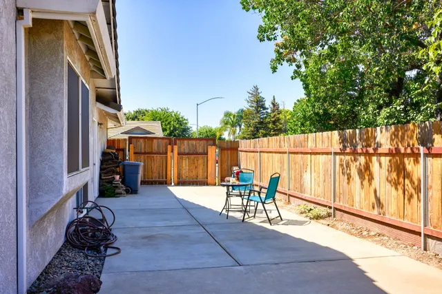 a view of a house with backyard and sitting area