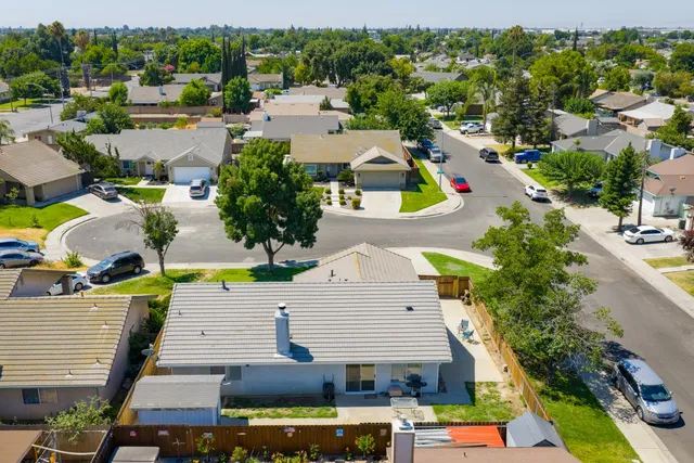 an aerial view of a house with swimming pool and outdoor space