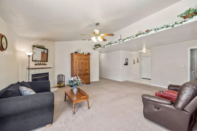 a living room with furniture a chandelier and a flat screen tv