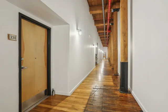 a view of hallway with wooden floor