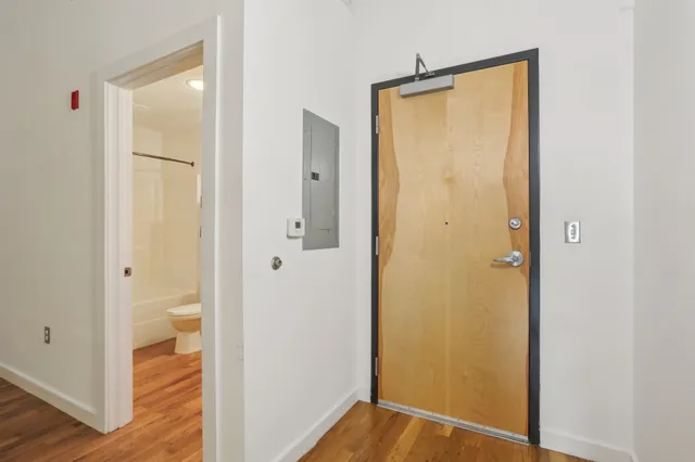 a view of bathroom with a hardwood and shower