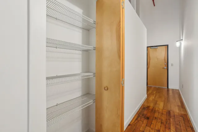 a view of a room with wooden floor