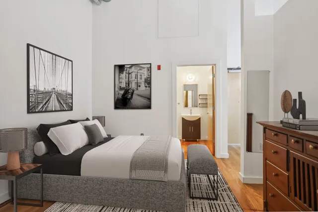a bedroom with furniture and wooden floor