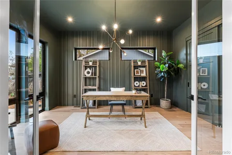 a living room with furniture a large window and stainless steel appliances