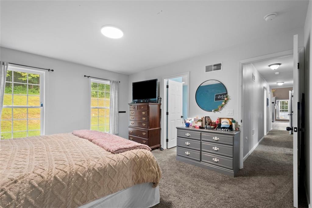 105 Jacobs Road Harrisville, PA 16038 - Photo 15 of 38 a bedroom with a bed and a mirror on the dresser