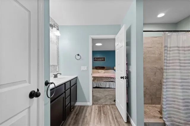 a bathroom with a sink a mirror and shower