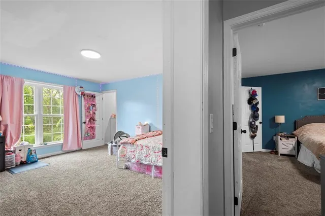 a bedroom with furniture and a window