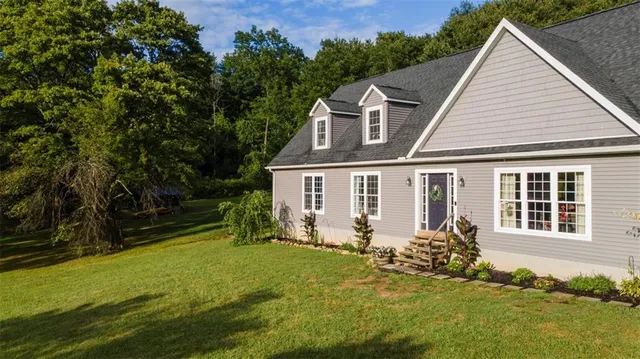a view of a house with backyard and sitting area