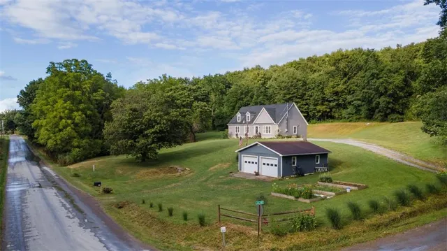 a aerial view of a house with a yard basket ball court and outdoor seating