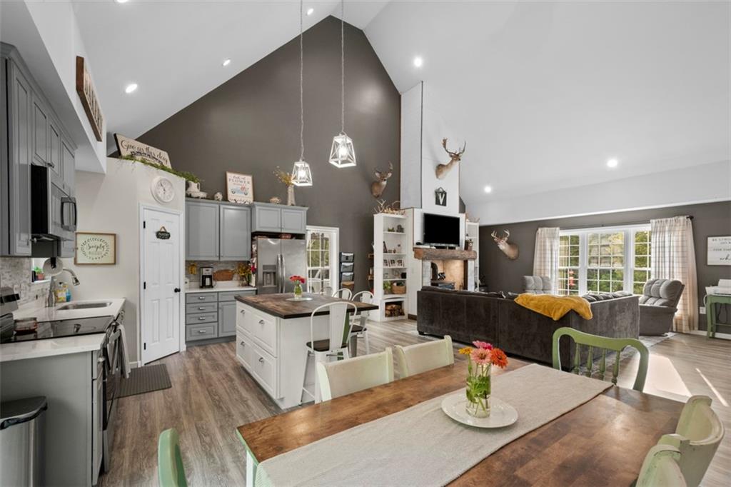 105 Jacobs Road Harrisville, PA 16038 - Photo 6 of 38 a view of a dining room with furniture a kitchen and chandelier
