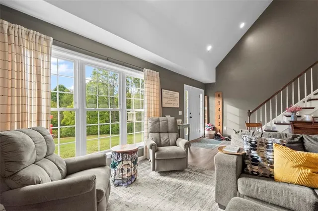 a living room with furniture and a large window