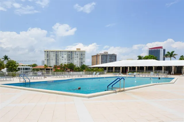 a view of an swimming pool with a yard and plants