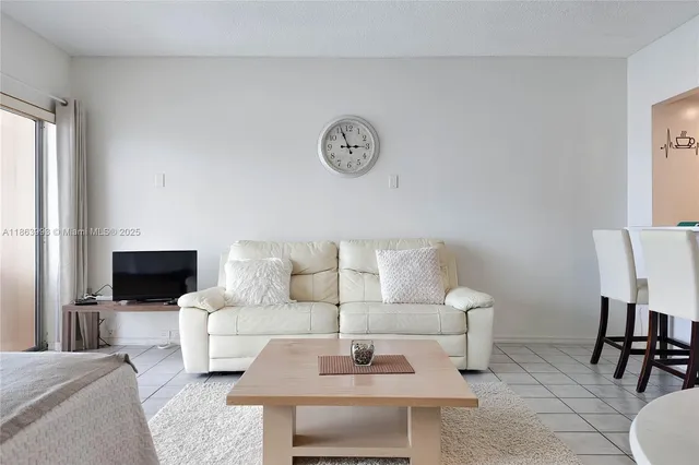 a living room with furniture a rug and a table
