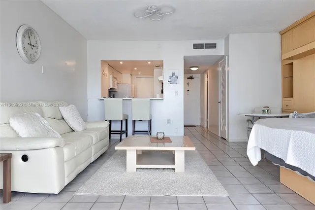 a living room with furniture and a mirror