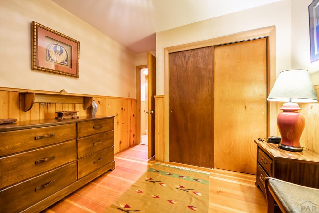 9600 Middle Creek Canyon Road Beulah, CO 81023 - Photo 30 of 50 a bedroom with a bed and wooden floor