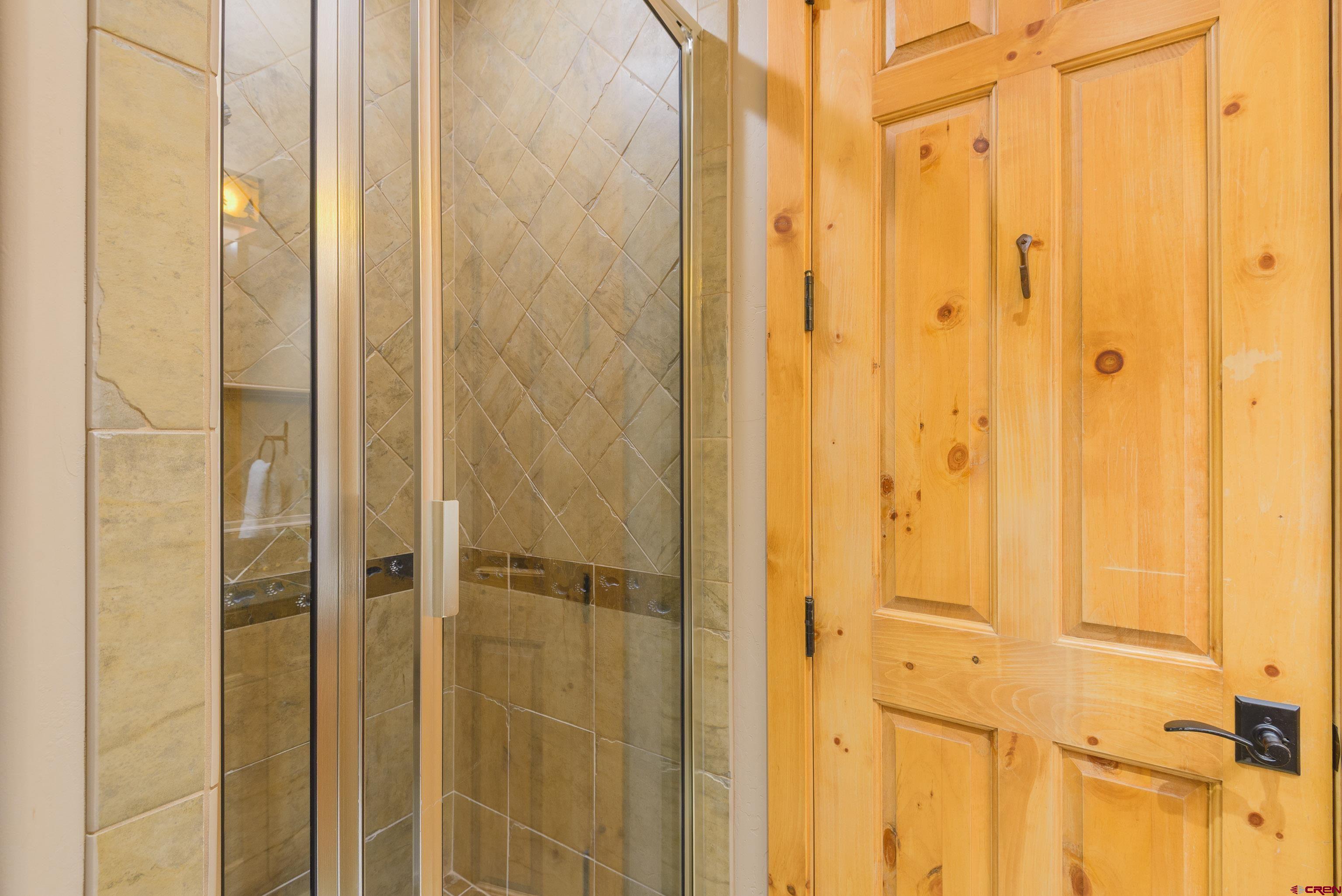 16 Snowmass Road, Unit 7 Crested Butte, CO 81225 - Photo 12 of 37 a bathroom with a glass door shower