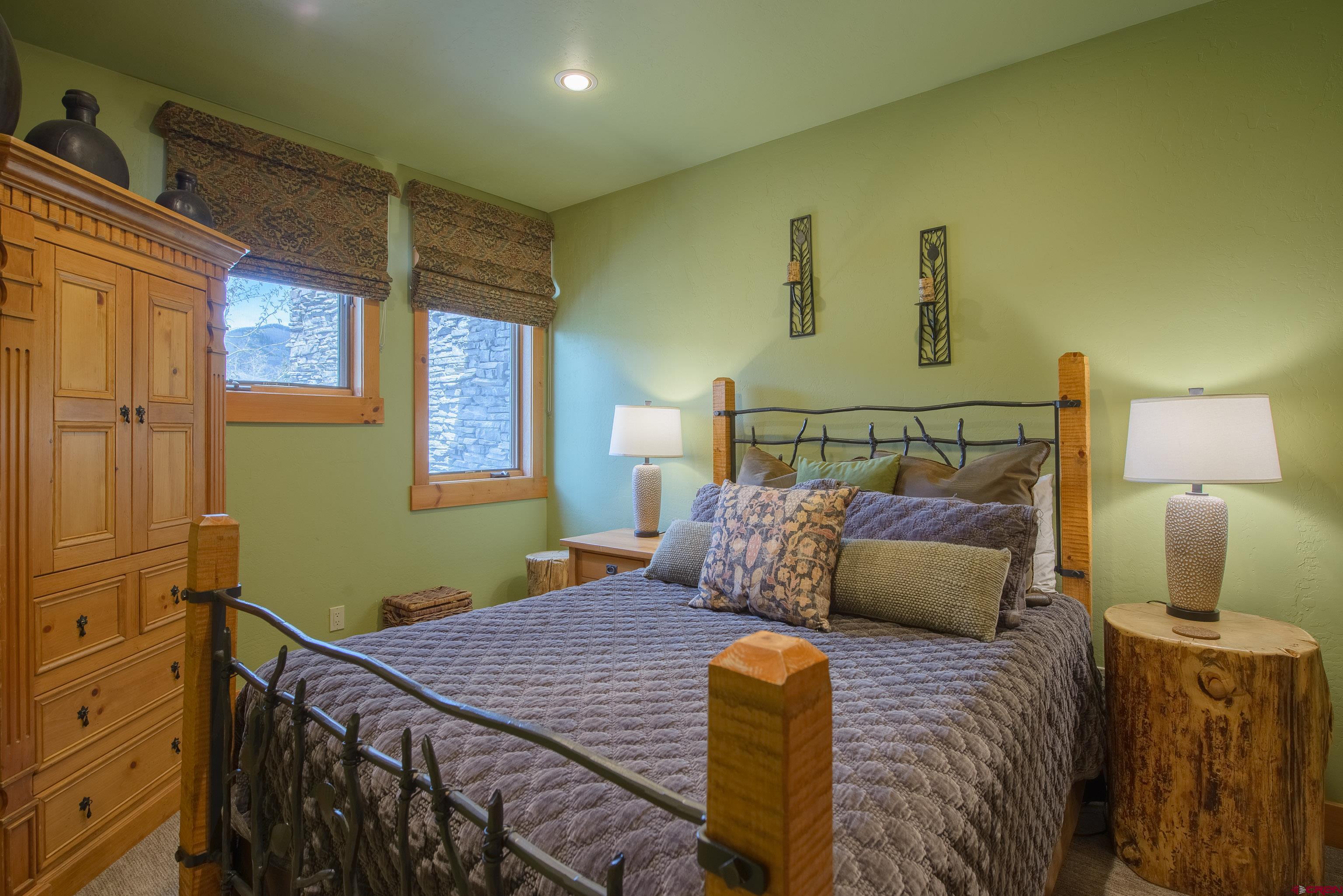 16 Snowmass Road, Unit 7 Crested Butte, CO 81225 - Photo 13 of 37 a bedroom with a bed and wooden floor
