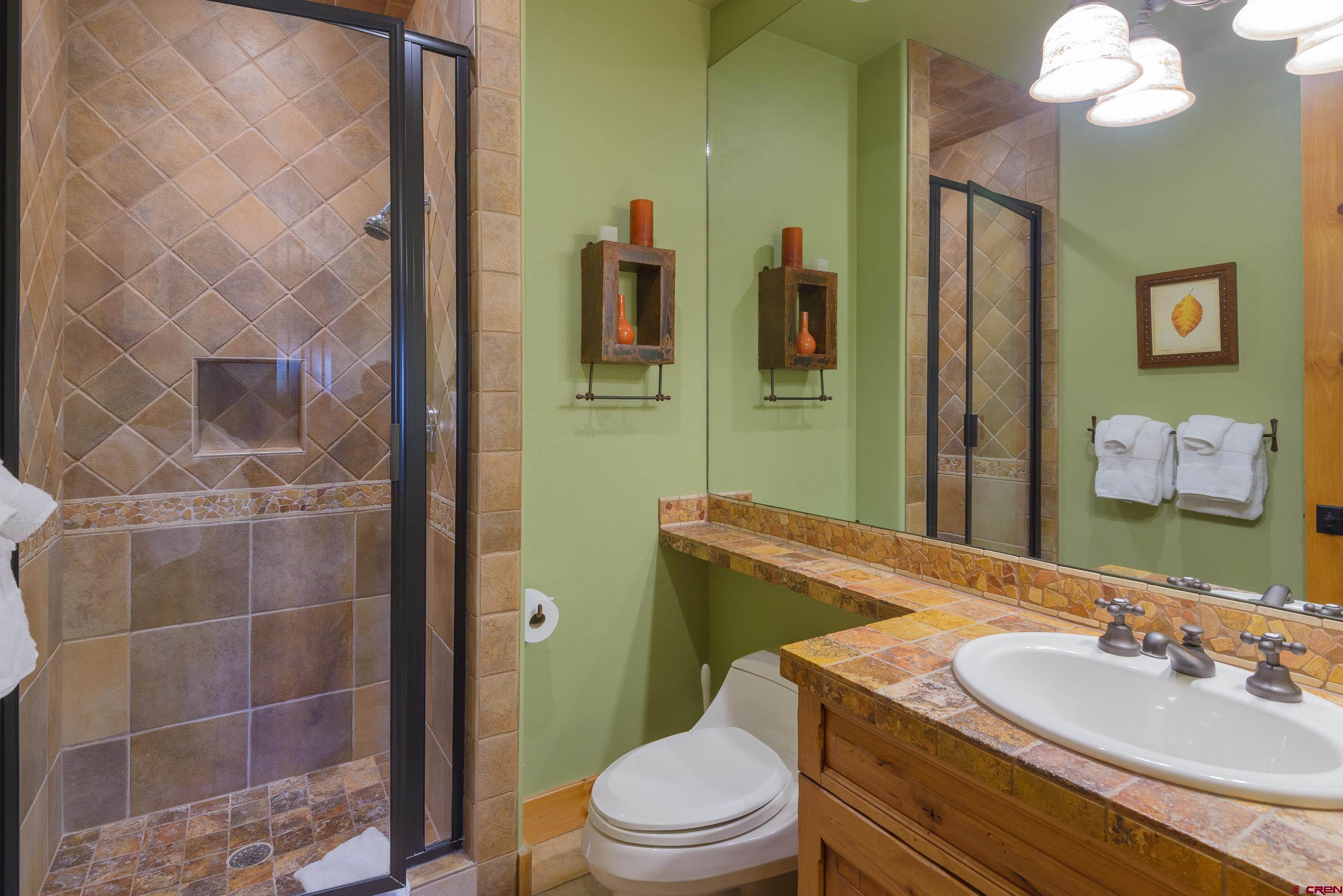 16 Snowmass Road, Unit 7 Crested Butte, CO 81225 - Photo 15 of 37 a bathroom with a sink a toilet and shower