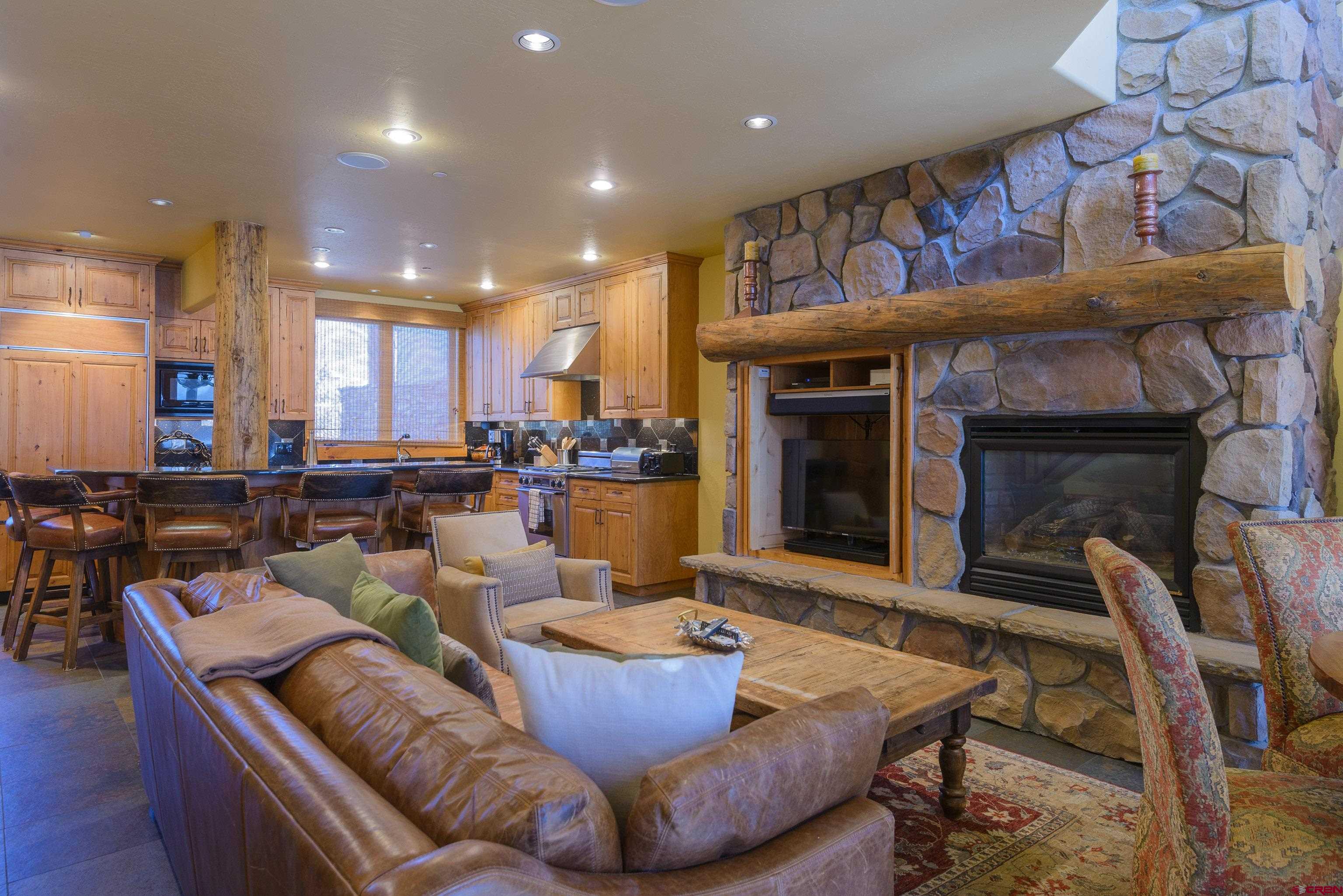 16 Snowmass Road, Unit 7 Crested Butte, CO 81225 - Photo 21 of 37 a living room with furniture and a fireplace