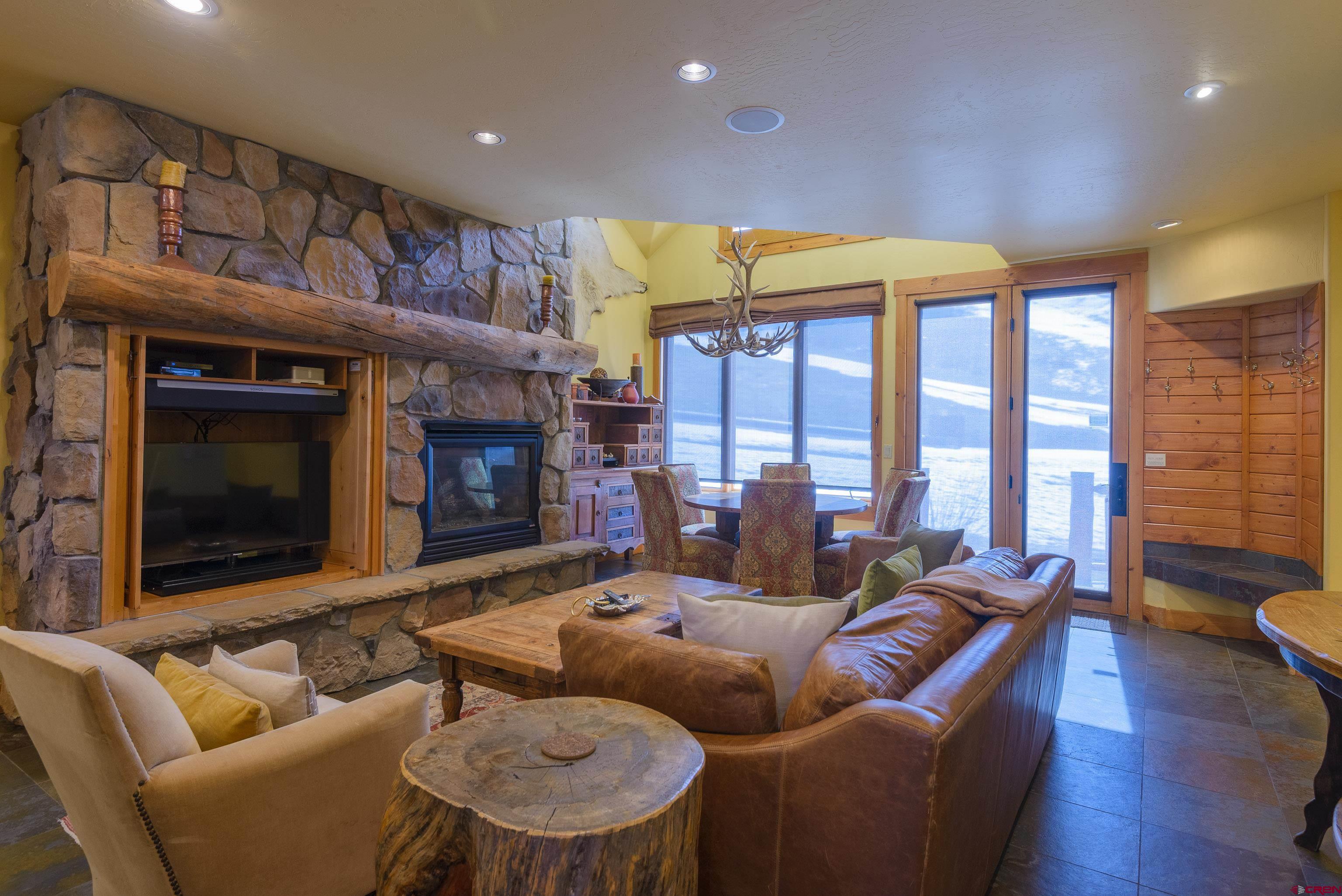 16 Snowmass Road, Unit 7 Crested Butte, CO 81225 - Photo 23 of 37 a living room with furniture and a fireplace