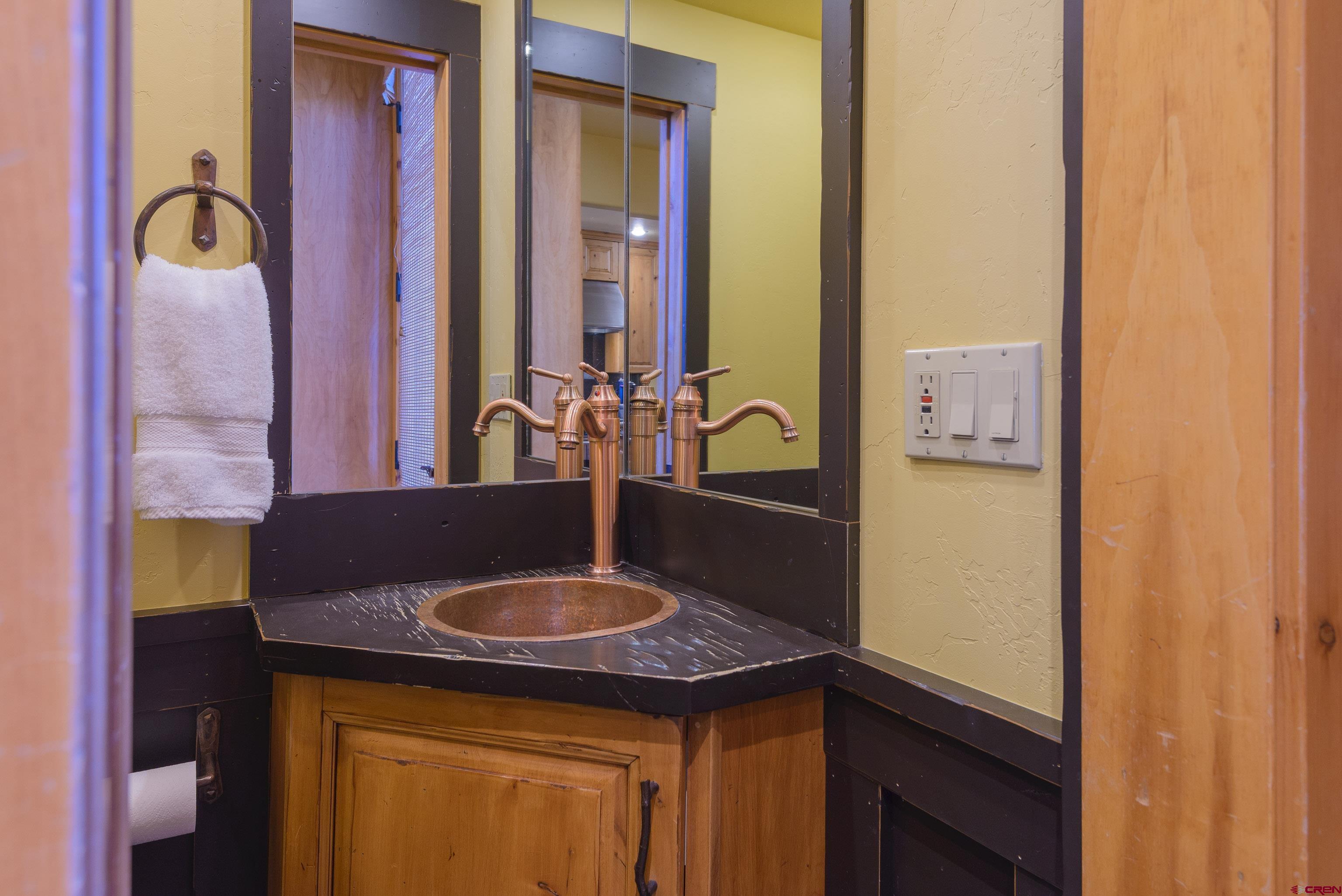 16 Snowmass Road, Unit 7 Crested Butte, CO 81225 - Photo 25 of 37 a bathroom with a granite countertop sink and a mirror