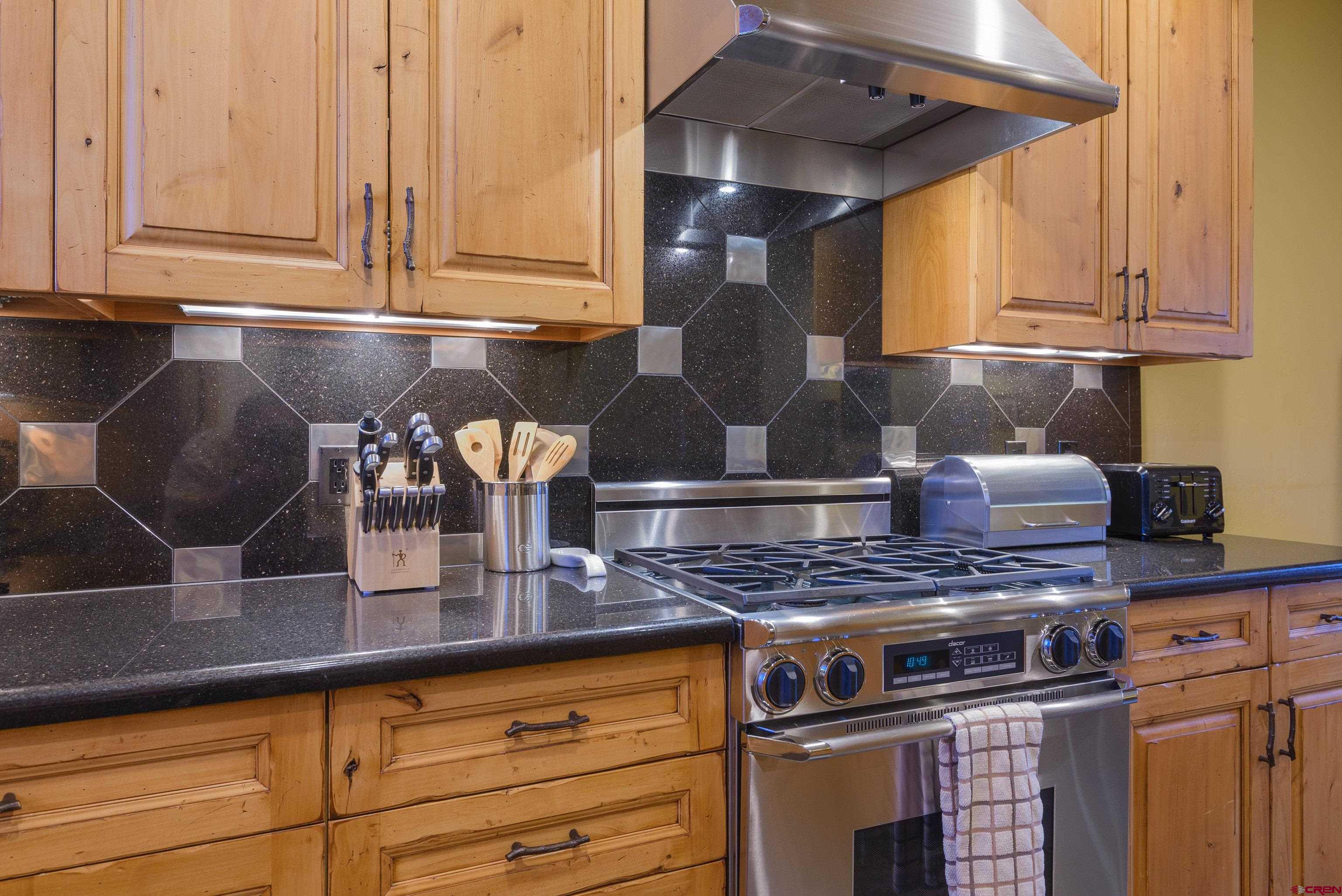 16 Snowmass Road, Unit 7 Crested Butte, CO 81225 - Photo 26 of 37 a kitchen with granite countertop a stove and a sink