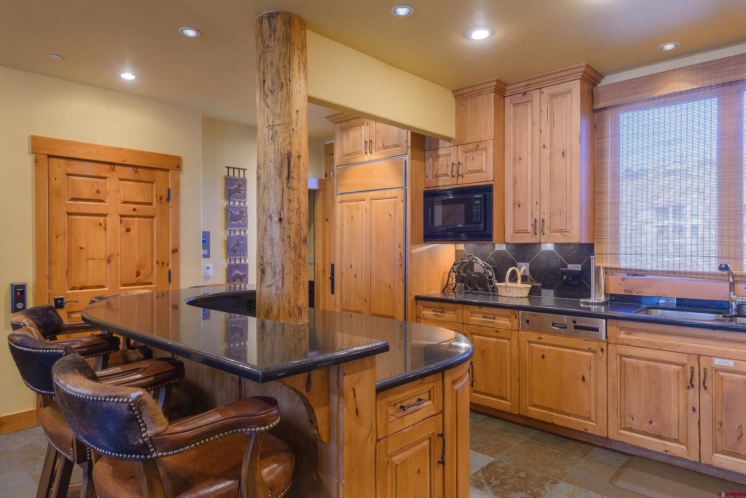 16 Snowmass Road, Unit 7 Crested Butte, CO 81225 - Photo 27 of 37 a kitchen with a refrigerator and a sink