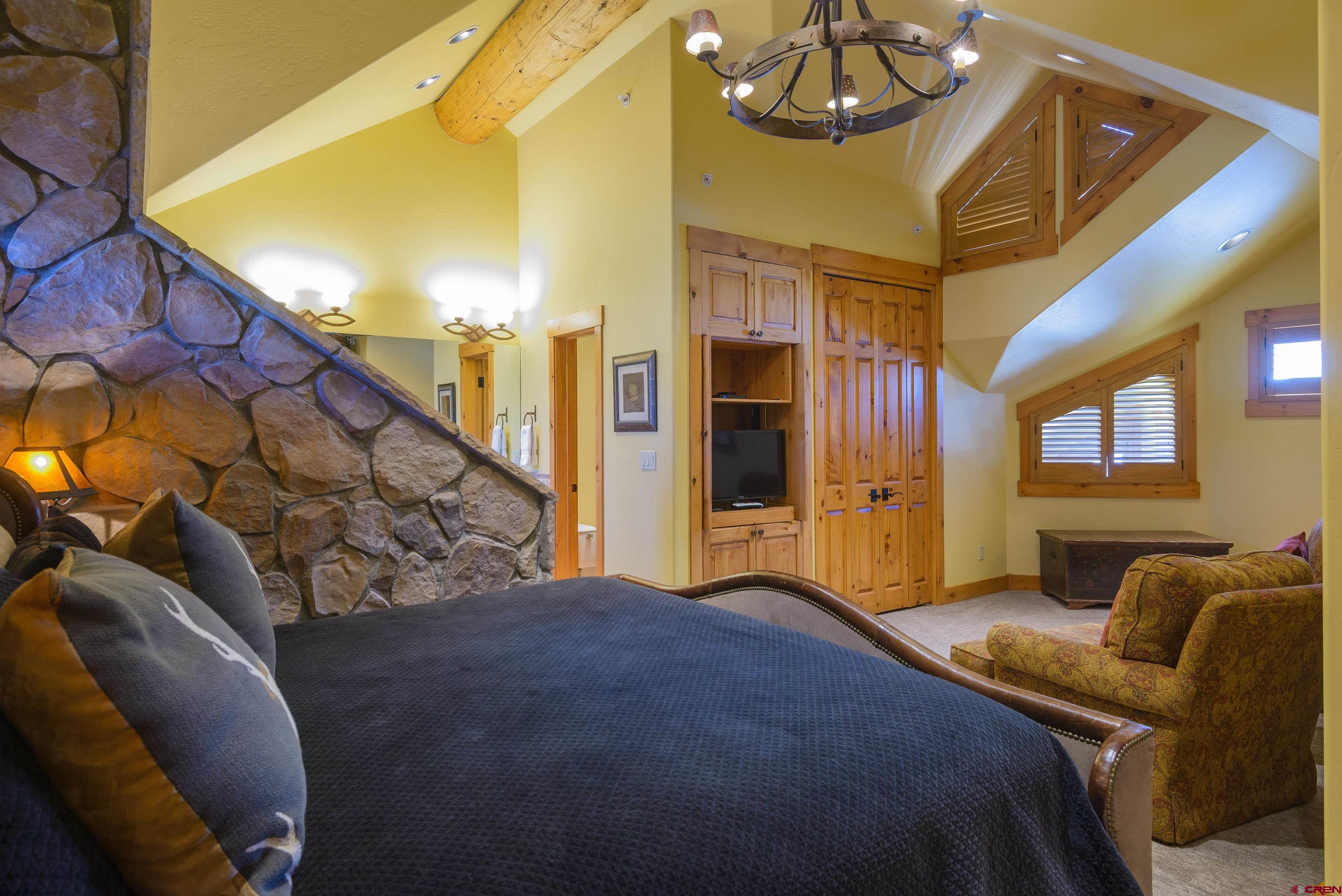 16 Snowmass Road, Unit 7 Crested Butte, CO 81225 - Photo 30 of 37 a bedroom with a bed and ceiling fan