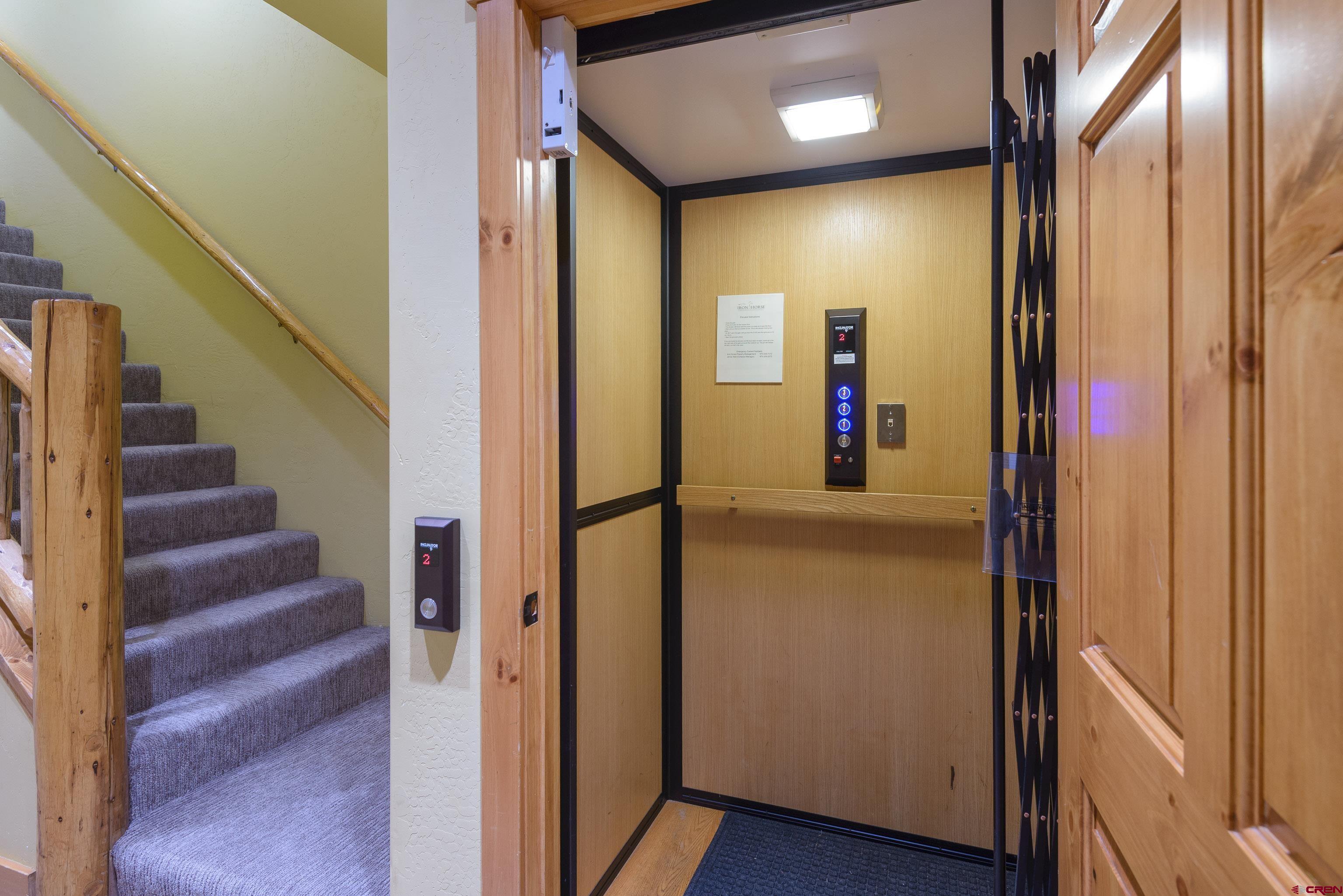 16 Snowmass Road, Unit 7 Crested Butte, CO 81225 - Photo 3 of 37 a view of a hallway with wooden floor and staircase