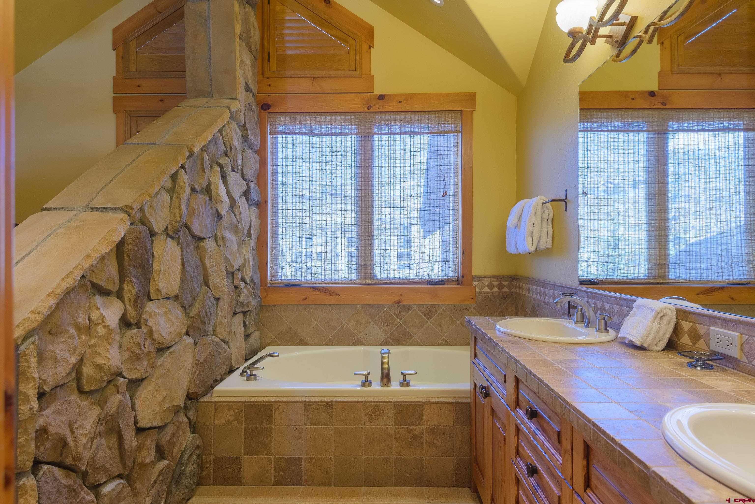 16 Snowmass Road, Unit 7 Crested Butte, CO 81225 - Photo 33 of 37 a bathroom with a tub sink and mirror