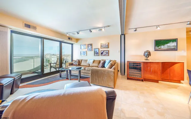 a bedroom with a large bed and a painting on the wall