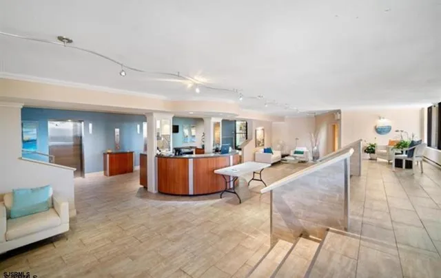 a living room with couches and kitchen view with wooden floor