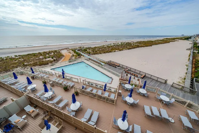 a living room with furniture and large windows