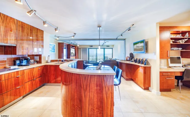a living room with furniture kitchen view and a large window